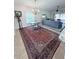 Bright dining area with vintage chandelier, table and chairs, rug, and view into living room at 663 Jamaica Cir, Lakeland, FL 33803
