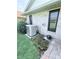 Well-maintained exterior featuring an AC unit surrounded by colorful flowerbed and landscaped area at 663 Jamaica Cir, Lakeland, FL 33803
