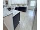 Modern kitchen with granite countertops, two-tone cabinets, and stainless steel appliances at 663 Jamaica Cir, Lakeland, FL 33803
