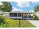 Spacious backyard with screened in porch and seating offers relaxation outdoors at 8851 Sw 116Th Street Rd, Ocala, FL 34481
