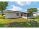 Backyard view of a screened-in lanai and fenced lawn at 8851 Sw 116Th Street Rd, Ocala, FL 34481