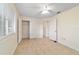 Bright bedroom featuring tile floors, ceiling fan, a window, and closet with white doors at 8851 Sw 116Th Street Rd, Ocala, FL 34481