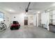 Garage featuring a lawn mower, white walls, and a door to the house at 8851 Sw 116Th Street Rd, Ocala, FL 34481