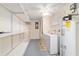 Bright laundry room with storage shelves, washer, and dryer at 8851 Sw 116Th Street Rd, Ocala, FL 34481