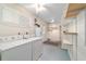 Bright laundry room with washer, dryer, water heater, and shelving at 8851 Sw 116Th Street Rd, Ocala, FL 34481