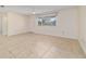 Bright living room showcasing neutral paint, tile floors, a window, and a white front door at 8851 Sw 116Th Street Rd, Ocala, FL 34481