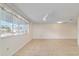 Bright living area featuring a ceiling fan, neutral paint, and large windows at 8851 Sw 116Th Street Rd, Ocala, FL 34481