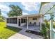 Outdoor patio with screened-in porch and seating offers relaxed outdoor living at 8851 Sw 116Th Street Rd, Ocala, FL 34481