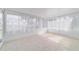 Bright sunroom with white trim, tile floor, and multiple windows at 8851 Sw 116Th Street Rd, Ocala, FL 34481