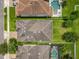 Aerial view showing the layout of houses with roofing and green lawns, including pools and driveways at 1138 Fountain Coin Loop, Orlando, FL 32828
