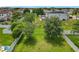 Large grassy backyard with white fence, mature trees, and a gazebo seating area, perfect for outdoor enjoyment at 1138 Fountain Coin Loop, Orlando, FL 32828