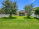 Spacious backyard with lush lawn, mature trees, and a patio area perfect for outdoor relaxation at 1138 Fountain Coin Loop, Orlando, FL 32828