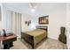 Cozy bedroom with hardwood floors, guitar art, ceiling fan and large window at 1138 Fountain Coin Loop, Orlando, FL 32828