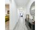 Bright hallway featuring tile flooring, arched doorways, and stylish decor leading to the bedroom and living areas at 1138 Fountain Coin Loop, Orlando, FL 32828