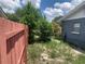 The backyard features lush greenery and a wooden fence at 119 Allen Ave, Winter Haven, FL 33880