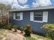 The home features a well maintained gray brick exterior with white shutters and neat landscaping at 119 Allen Ave, Winter Haven, FL 33880