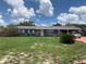 Charming single-story home with gray brick exterior, well-maintained lawn, and a covered carport at 119 Allen Ave, Winter Haven, FL 33880