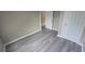 Bright bedroom offering new flooring, neutral walls, and closet space at 1514 Crest Ave, Leesburg, FL 34748