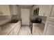 Updated kitchen featuring granite countertops, white cabinets, subway tile backsplash and modern appliances at 1514 Crest Ave, Leesburg, FL 34748