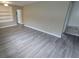 Spacious living room with new flooring and a built-in bookcase, ready for comfortable living at 1514 Crest Ave, Leesburg, FL 34748