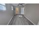 Bright living room with new flooring, a ceiling fan, and a door to the outside patio at 1514 Crest Ave, Leesburg, FL 34748