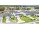 Aerial view of the homes featuring well-maintained lawns and 2-car attached garages at 1518 Louise Ave, Auburndale, FL 33823
