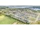 Aerial view of homes and community amenities including pool, ponds and green spaces at 1518 Louise Ave, Auburndale, FL 33823