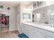 Bathroom featuring a double vanity with marble countertops, decorative accents, and a walk-in shower for spa-like comfort at 1518 Louise Ave, Auburndale, FL 33823
