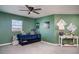 Green bedroom with a trundle bed, decorative wall art, and a ceiling fan for added comfort at 1518 Louise Ave, Auburndale, FL 33823