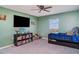 bedroom with a trundle bed, bookshelf, television and ceiling fan at 1518 Louise Ave, Auburndale, FL 33823