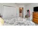 Comfortable bedroom with a floral patterned bed, ample closet space, and soft lighting for a relaxing ambiance at 1518 Louise Ave, Auburndale, FL 33823