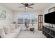 Bright bonus room featuring a sofa, exercise bike, and a large window for natural light at 1518 Louise Ave, Auburndale, FL 33823