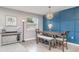 Dining room with a striking navy accent wall and modern light fixture at 1518 Louise Ave, Auburndale, FL 33823