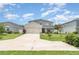 Charming two-story home with a manicured lawn, a driveway and lovely landscaping at 1518 Louise Ave, Auburndale, FL 33823