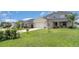 A well-manicured lawn and landscaping complement this lovely two-story home at 1518 Louise Ave, Auburndale, FL 33823
