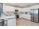 Modern kitchen featuring white cabinetry, stainless steel appliances, and light-colored countertops at 1518 Louise Ave, Auburndale, FL 33823
