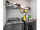 Functional laundry room equipped with modern washer and dryer units, and ample storage space for household essentials at 1518 Louise Ave, Auburndale, FL 33823