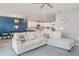 Open-concept living room with a dining area and a view into the kitchen featuring white cabinetry at 1518 Louise Ave, Auburndale, FL 33823