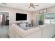 Cozy living room featuring a plush sectional sofa, large TV, and sliding glass doors at 1518 Louise Ave, Auburndale, FL 33823