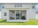The screened in porch features a ceiling fan, furniture, and outdoor grill at 1518 Louise Ave, Auburndale, FL 33823