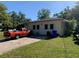 Exterior view of a single-story home with a red pickup truck in the driveway on a sunny day at 550 W Oak Dr, Lakeland, FL 33803