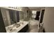 Spacious bathroom with dual sinks, a soaking tub, and modern fixtures at 528 Winding Oak Ln, Longwood, FL 32750
