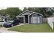 Charming single-story home with a well-maintained lawn and a modern grey facade at 528 Winding Oak Ln, Longwood, FL 32750