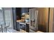 Modern kitchen features stainless steel appliances, dark cabinetry, and stone countertops at 528 Winding Oak Ln, Longwood, FL 32750