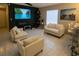 Modern living room with tile floors, a large screen tv, and comfortable seating at 528 Winding Oak Ln, Longwood, FL 32750