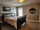 Relaxing bedroom with wood-look floors, a comfortable bed, and calming decor accents at 2509 Montecito Ave, Eustis, FL 32726