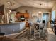 Open dining area with stylish lighting, a decorative rug, and a view into the modern kitchen at 2509 Montecito Ave, Eustis, FL 32726