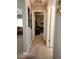 Hallway view leading to living room and spare room or office area with neutral walls and carpet at 2509 Montecito Ave, Eustis, FL 32726