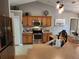 Efficient kitchen with stainless steel appliances, wood cabinetry, and ample counter space for cooking at 2509 Montecito Ave, Eustis, FL 32726
