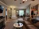 Comfortable living room featuring carpet flooring, a fireplace, and easy access to the kitchen at 2509 Montecito Ave, Eustis, FL 32726